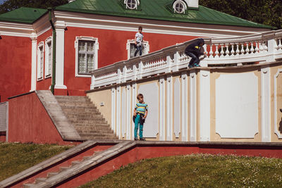 Boy standing outside building