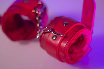 High angle view of red leather handcuffs on table