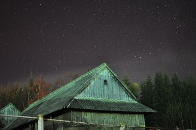 Old houses against star field at night