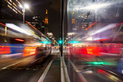 Blurred motion of train on city street at night