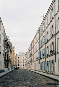 Street amidst buildings against sky