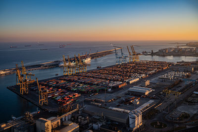 High angle view of barcelona port city at sunset