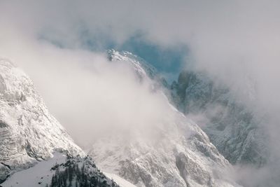 Scenic view of snow covered mountains against sky