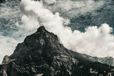 Low angle view of rocky mountains against sky