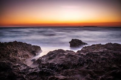 Scenic view of sea at sunset