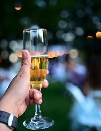 Close-up of hand holding beer glass