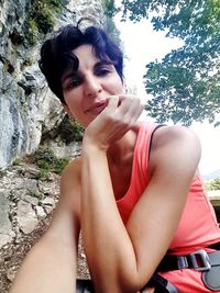 Portrait of young woman sitting outdoors