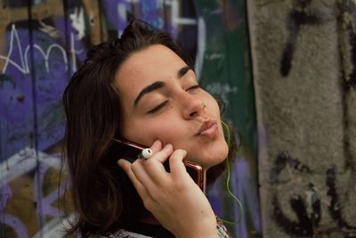 Close-up portrait of young woman with eyes closed