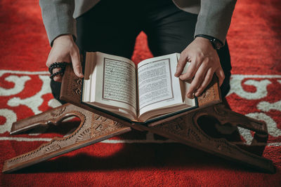 Midsection of woman reading book