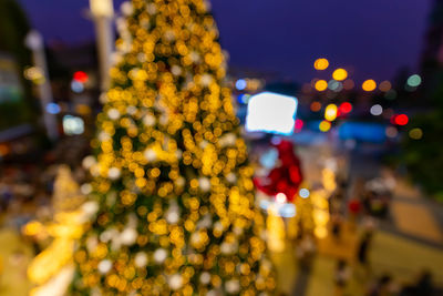 Defocused image of illuminated christmas tree at night