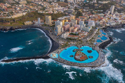 Swimmingpool lago martiánez in puerto de la cruz drone view at stormy weather.