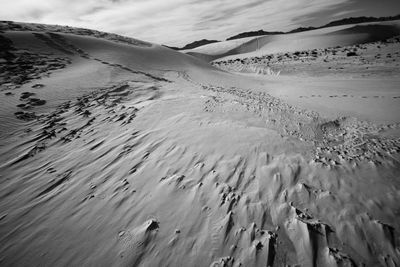 Close-up of sand dunes against sky