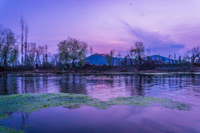 Scenic view of lake against sky at sunset