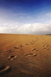 Scenic view of desert against blue sky