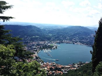 High angle view of city by sea against sky