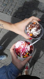 High angle view of woman holding ice cream in bowl