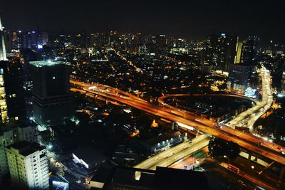 High angle view of city lit up at night