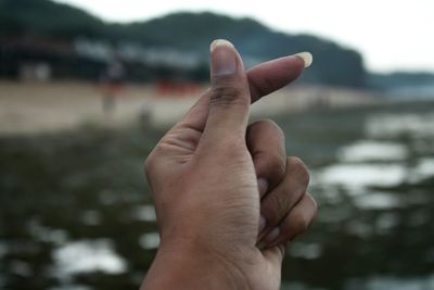 Cropped hand of woman outdoors