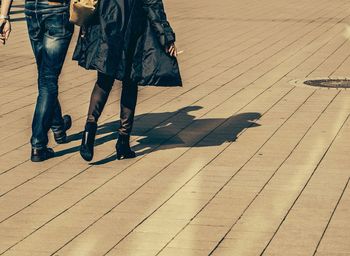Low section of woman standing on tiled floor