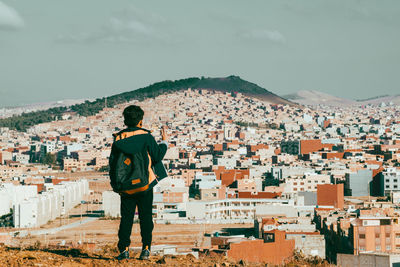 Rear view of man standing on mountain