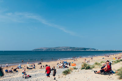 People on beach against sky