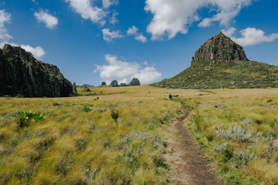 Rear view of a hiker against a mountain at the la satima dragons teeth in the aberdares, kenya