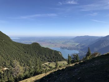 Scenic view of mountains against blue sky