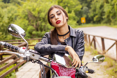 Portrait of beautiful woman siting on motorcycle