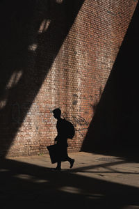 Silhouette woman walking on street