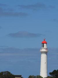 Lighthouse by sea against skyline 