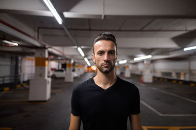 Portrait of young man standing in bus