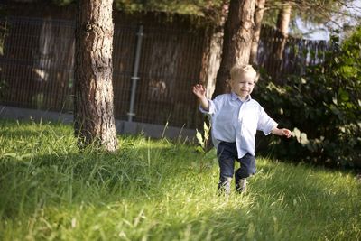 Full length of boy standing on field