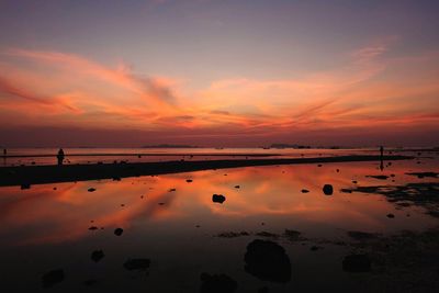 Scenic view of beach against sky during sunset