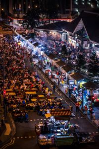 High angle view of people in street market at night