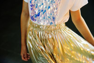 Midsection of woman standing against blurred background