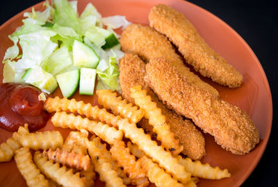 High angle view of fried chicken with french fries in plate