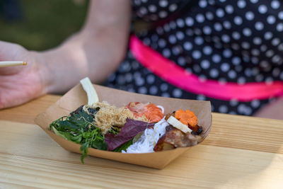 Cropped hand of person preparing food on cutting board