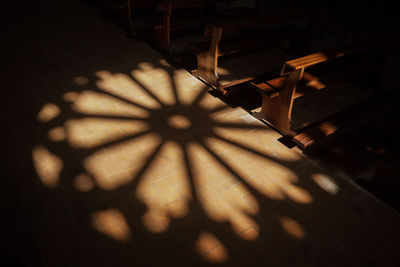 High angle view of illuminated shadow on metal