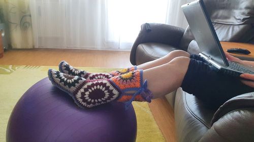 High angle view of woman relaxing on sofa at home