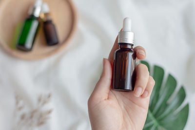 Close-up of woman hand holding bottle