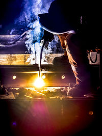 Close-up of man working at night