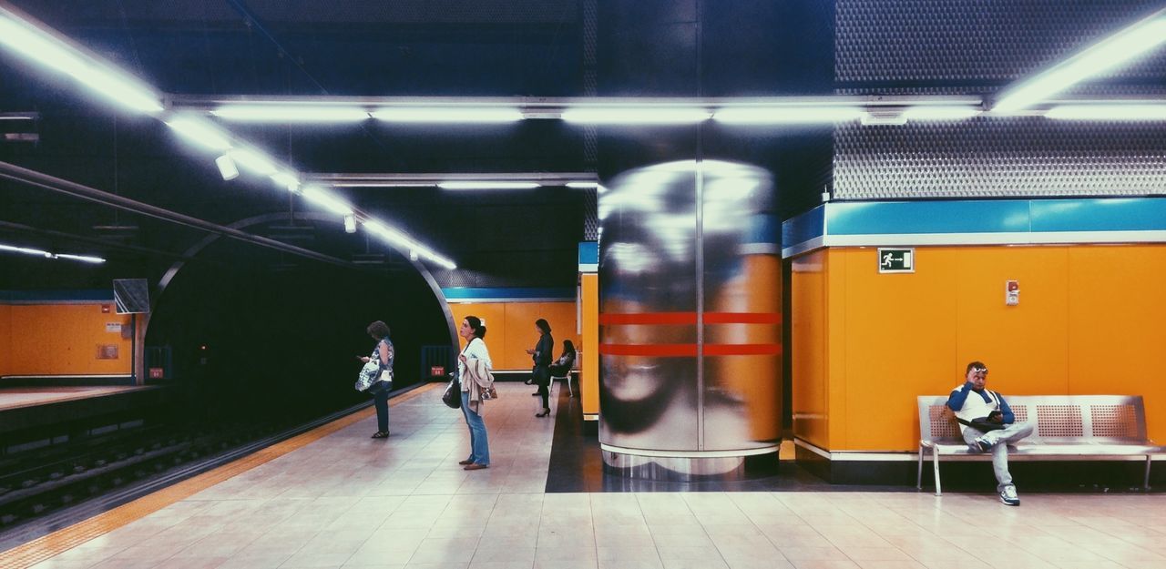 indoors, transportation, men, public transportation, mode of transport, illuminated, railroad station, subway station, travel, lifestyles, rail transportation, railroad station platform, subway, train - vehicle, passenger, person, full length, leisure activity