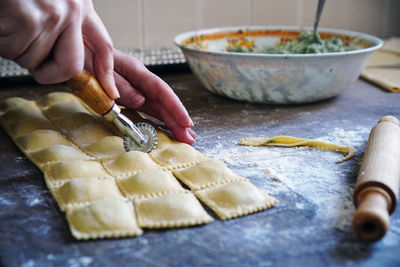 Midsection of person preparing food in kitchen