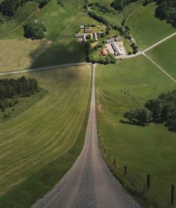 Road amidst field against sky