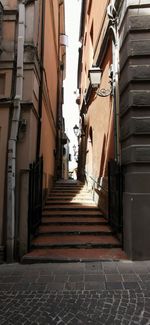 Low angle view of narrow alley amidst buildings