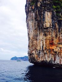 Rock formation in sea against sky