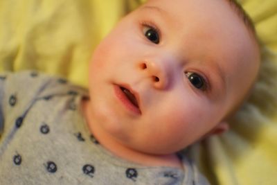 Close-up of cute baby on bed