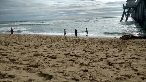 People on beach against sky