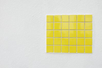 Directly above shot of yellow paint on white wall