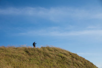 Man on field against sky